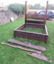 An Antique carved rosewood double bed, carved with thistles and scrolls, width 66ins, length