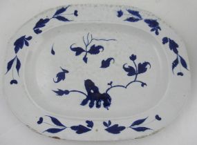 An Antique tin glazed oriental style blue and white meat plate, with floral decoration