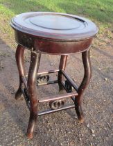 A circular oriental style jardiniere stand, diameter 14ins, height 19ins