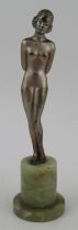 Lorenzl, a patinated bronze figure, of a nude girl with arms crossed behind her back, height 7.5ins