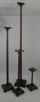 A set of four early 20th century oak and mahogany graduate shop fitting hat display stands, by