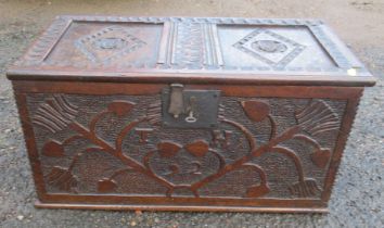 A small antique oak coffer with two panel lid, the front carved with inititals T.H and dated '92 ,