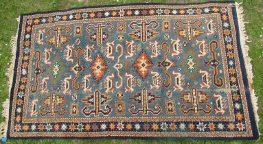 A Kabistan Eastern design rug, decorated in blue and orange with repeating symbols, 39ins x 68ins,