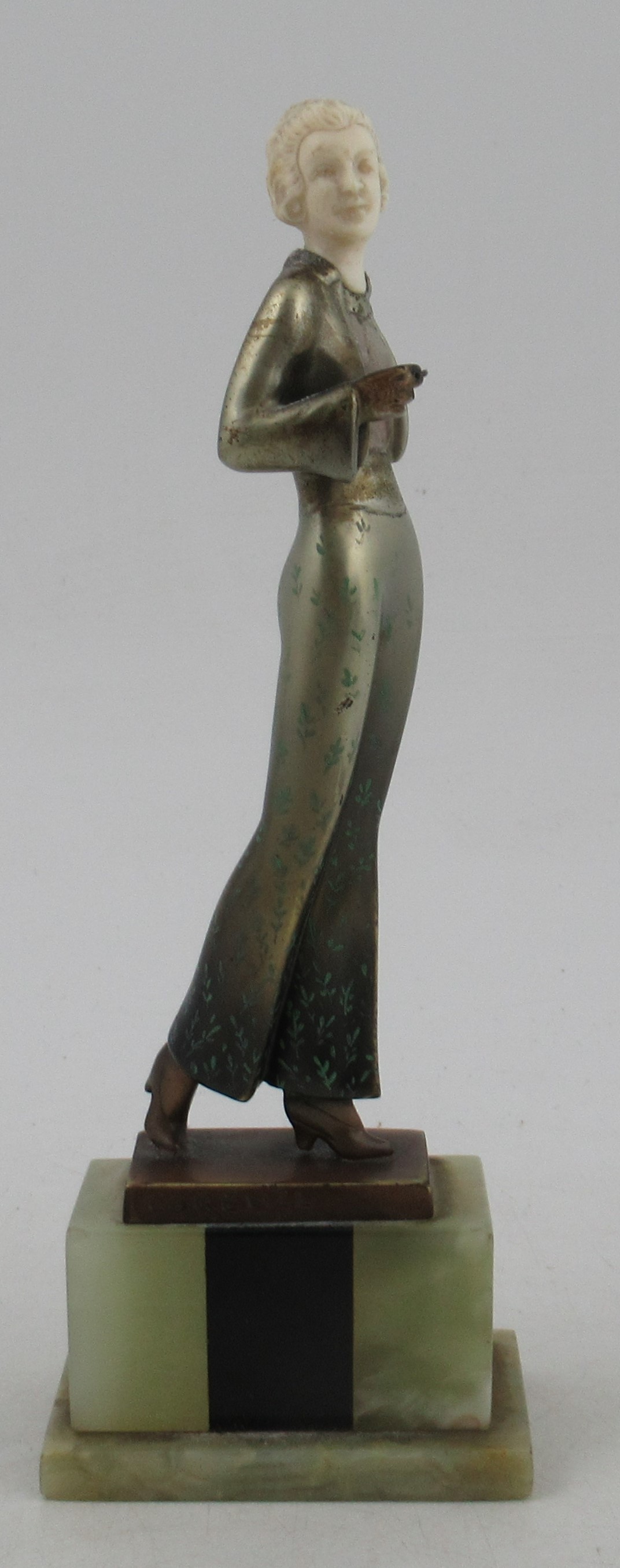 Lorenzl, a patinated bronze and ivorine figure, of a stylish Art Deco woman, signed to bronze