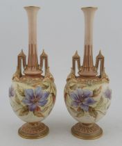 A pair of Royal Worcester vases, decorated with flowers and stylized arch handles, shape No 1406,