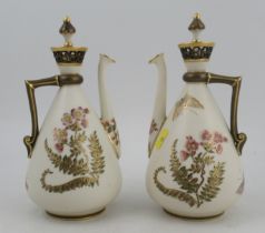 A pair of Royal Worcester Persian style gilt ivory ewers, with stoppers and pierced necks, decorated