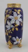 A Royal Worcester spill vase, with knurl feet and pierced neck, decorated with flowers and gilt