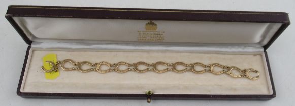 A 9ct gold bracelet, made up of horseshoes joined by chains, marked 375, weight 9.5g, in a Garrard