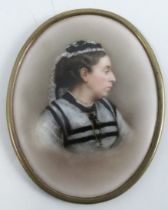 A 19th century oval porcelain plaque, decorated with a portrait of a woman wearing black and