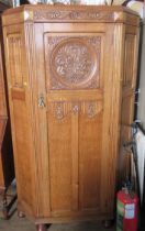 An oak hall cupboard, with carved decoration, height 73ins, width 43ins