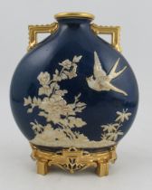A Royal Worcester pilgrim flask vase, decorated in relief with a bird and foliage to a Sabrina