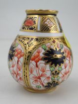 A Royal Crown Derby baluster shape vase, decorated with an Imari pattern, height 2.5ins