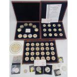 Three cased enamel and gilt coin sets, together with other commemorative coins