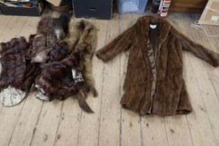 A fur coat and assorted fur items