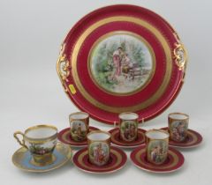 A Continental porcelain circular tray and five coffee cans and saucers, all decorated with figures