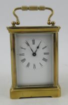 A brass cased carriage clock, with white enamel dial and Roman numerals, stamped R & Co Made in