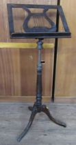 A 19th century faux rosewood adjustable music stand, with brass mounts