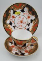 A Royal Crown Derby Trio, comprising a tea cup, saucer and side plate, decorated in the Imari