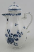 A German porcelain covered hot water jug, decorated in under glazed blue with flowers and