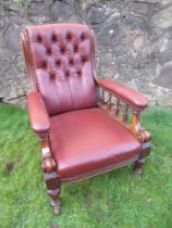 A Victorian show wood open arm chair with leather seat, back and arms raised on turned feet