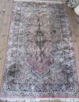 An Indian rug, with scrolling leaf decoration, 78ins x 48ins