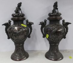A pair of Eastern metal covered vases, decorated with birds and animals, height 11.5ins