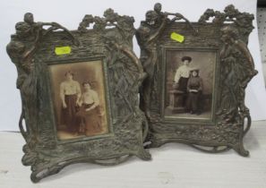 A pair of Art Nouveau style metal photograph frames, decorated with a woman and flowers, marked to