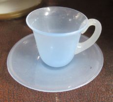 A glass cabinet miniature cup and saucer