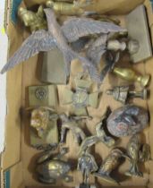 A collection of brass and metal figures and badges