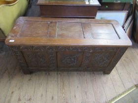 An antique style oak coffer with fielded panels, width 47ins, depth 19ins, height 23ins