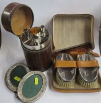 A cased pair of silver backed brushes, together with silver mounted comb, a cased German silver