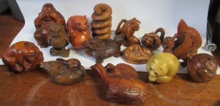 15 carved netsukes, some in wood some in resin