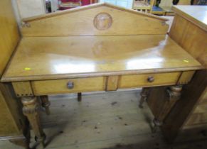 A 19th century oak sidetable, carved with a shield to the back, fitted two frieze drawers, on inlaid