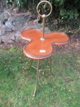 An Edwardian mahogany butler's occasional table , revolving brass galleried trefoil top on three