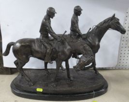 A metal model, of two racehorses with jockeys, signed to the oval base, height 15ins