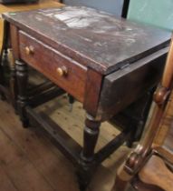 A stained pine sidetable, with drop flap to one end, fitted with a frieze drawer, 36ins (flap up)