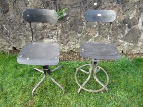 Two similar industrial style office chairs