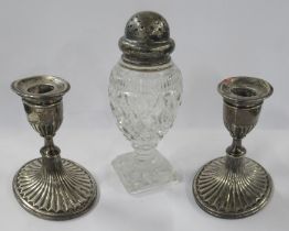 A pair of Victorian silver candlesticks, together with a silver topped pepper