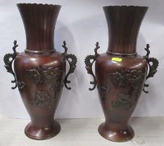 A pair of Eastern metal vases, decorated with flowers, height 14.5ins