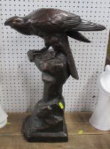 A glazed pottery model, of an eagle on a stump, marked to base, height 21ins