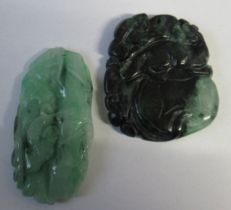 Two green jade style discs, one carved with a mythical beast, the other with foliage, height 2ins