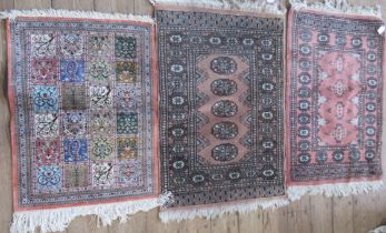 Three Eastern design small rugs, 2 38ins x 26ins and 31ins x 23ins