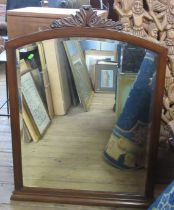 A mahogany framed wall mirror, with carved decoration to the top