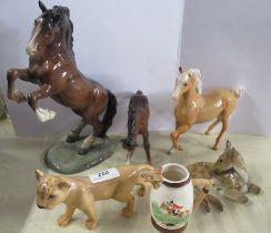 A collection of Beswick china to include Lion, horses, rearing horses, some af