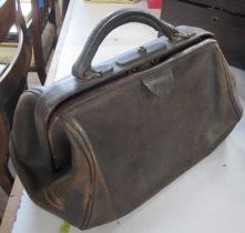 A small leather Gladstone style bag