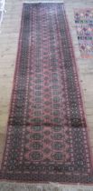 A pink ground runner, 120ins x 32.5ins, together with a mat, 54ins x 21ins
