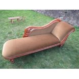 A Victorian chaise longue, with green upholstery