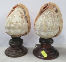 Two carved cameo shells, on wooden stands, height 7.5ins and 8ins