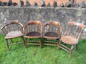 A pair of oak curved back chairs, with spindle supports, together with two other chairs