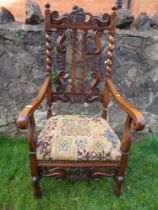 An  antique elm open arm chair the pierced back decorated with craved crowns the back stamped, "